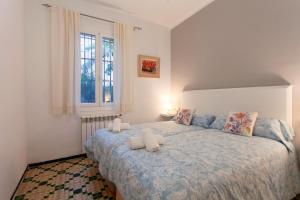 una camera da letto con un letto con un piumone blu e una finestra di Can Duran a Palma de Mallorca