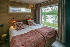 מיטה או מיטות בחדר ב-Holiday Village Nuorgamin Lomakeskus