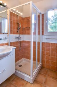 a bathroom with a shower and a sink at CYRNOS in Porto-Vecchio