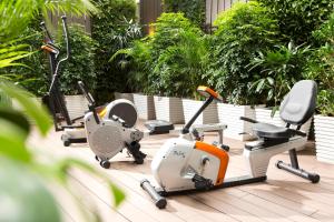 a row of exercise bikes on a patio at iclub Fortress Hill Hotel in Hong Kong