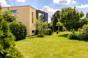een huis met een tuin met gras en bomen bij Hotel F-RITZ in Schleswig