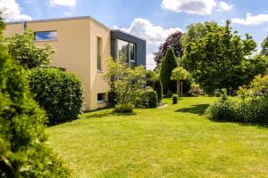 a house with a yard with grass and trees at Hotel F-RITZ in Schleswig