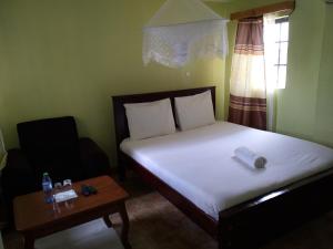 Postel nebo postele na pokoji v ubytování Crown Hotel Kericho