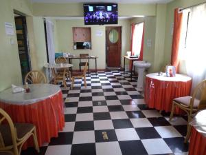 a restaurant with a black and white checkered floor at Crown Hotel Kericho in Kericho