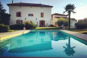 a large swimming pool in front of a house at Le Hameau du Buron - "Le Petit Buron" - Option SPA in Eyzin-Pinet