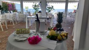 a table with a plate of fruit on it at Relais Maresca Luxury Small Hotel & Terrace Restaurant in Capri