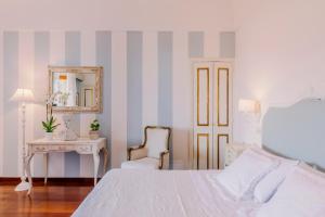 a bedroom with a bed and a table with a mirror at Villa Mary Suites in Positano