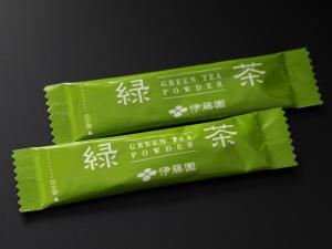 three packets of green tea powder on a black background at APA Hotel Roppongi SIX in Tokyo