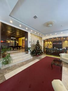 a large lobby with a christmas tree in the center at Premier Hotel in Nizhny Novgorod