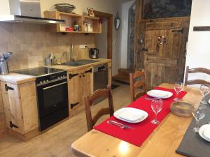 a kitchen with a wooden table with a dining room at La Lauze village house in Clarée Valley 4P in Val-des-Prés