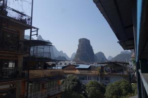 a view of a town with mountains in the background at Climbers Inn Yangshuo in Yangshuo