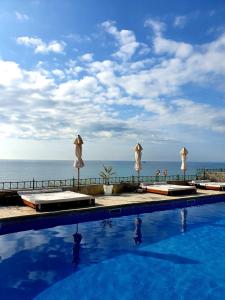 a swimming pool with a view of the ocean at Peter Hotel in Ravda