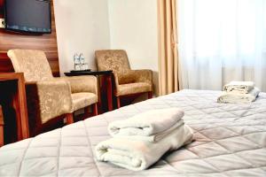 Postel nebo postele na pokoji v ubytování Hotel Komfort