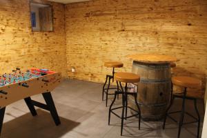 a room with a table and stools and a table andbeer barrel at L'esperluette in Spa