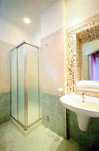 a bathroom with a sink and a shower at Hotel Baltic in Misano Adriatico