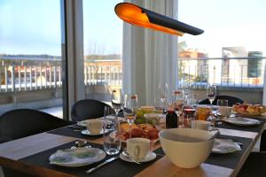 a dining room table with a view of a balcony at DünenResort Ostseebad Binz in Binz