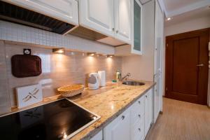 - une cuisine avec un évier et un comptoir dans l'établissement Victus Apartamenty, Apartament Liczi, à Sopot