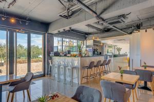 a room with tables and chairs and a bar at Hotel Pax in Split