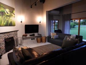 a living room with a couch and a television at 10 Mount Champagne in Champagne Valley