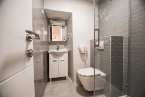 a small bathroom with a toilet and a shower at Villa San Antonio 3-PALADA in Baška +21 photos