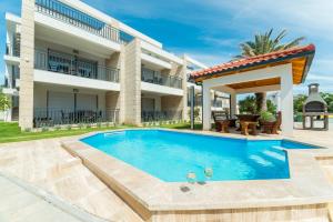 a swimming pool in the backyard of a house at Villa Mirakul in Vir