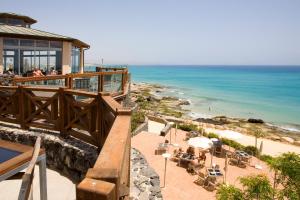 a view of the ocean from a balcony of a beach at R2 Hotel Pajara Beach in Costa Calma