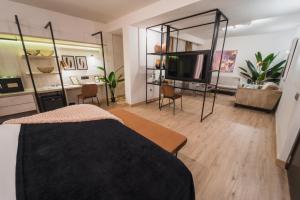 a bedroom with a bed and a tv in a room at Hotel Taburiente S.C.Tenerife in Santa Cruz de Tenerife