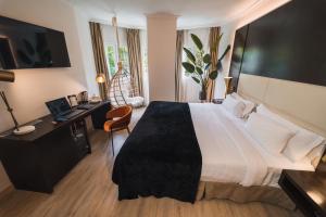 a hotel room with a large bed and a desk at Hotel Taburiente S.C.Tenerife in Santa Cruz de Tenerife