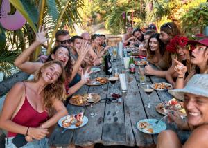 a group of people sitting at a table eating food at Begadang in Gili Islands