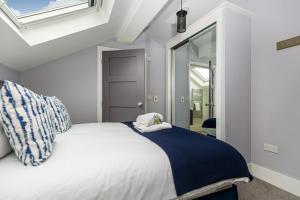 a bedroom with a white bed and a window at Luxury Loft Apartment by Bootique Wakefield in Wakefield