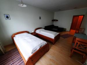 a bedroom with two beds and a desk and a table at Gasthof Haudum in Helfenberg