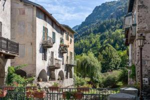 a group of buildings with a view of a mountain at Sunny 1-Bed apartment in lovely mountain village in La Brigue