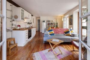 a living room with a couch and a kitchen at Sunny 1-Bed apartment in lovely mountain village in La Brigue