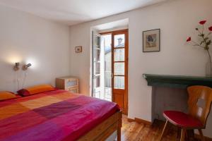 a bedroom with a bed and a fireplace at Sunny 1-Bed apartment in lovely mountain village in La Brigue