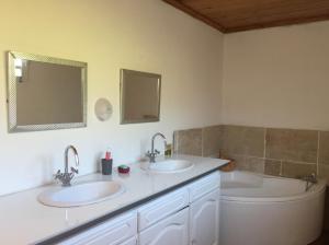a bathroom with two sinks and a tub at Madeleine Rose in Cilaos