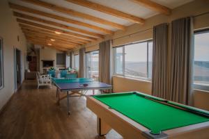 two pool tables in a room with windows at Melk Houte Bosch Manor House in Swellendam