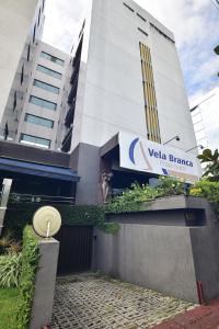 a building with a velta france sign in front of it at Rede Andrade Vela Branca in Recife