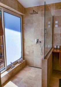 a bathroom with a shower with a large window at Lotus Garden - Île de la Réunion in Ravine des Cabris