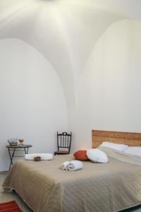 a bedroom with a large bed with two pillows on it at La Chicca in centro Altamura in Altamura