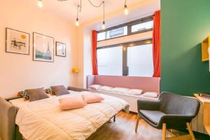 a bedroom with a bed and a chair and a window at New and Cosy in heart of Paris, 12e, 4pers in Paris