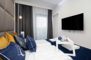 Łóżko lub łóżka w pokoju w obiekcie Apartamenty Gardenia Seaside by Noclegi Renters