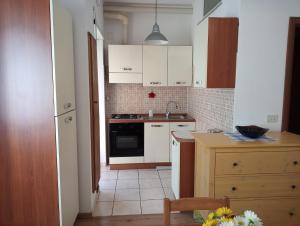 a kitchen with white cabinets and a stove top oven at Gilda Vacanze Metro Battistini in Rome