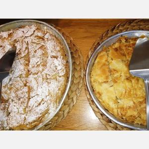 a pie in a pan on a wooden table at Celini Suites Hotel in Marmari