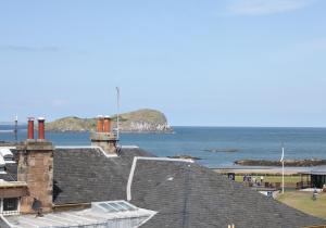 a view of the ocean from the roof of a building at Apartment Sula Bassana in North Berwick