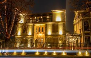 a building with lights in front of it at night at Vila EKREM in Korçë