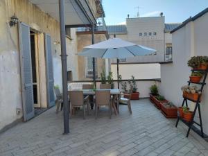 a patio with a table and an umbrella at da Irma in terrazza in Crema