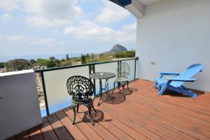a balcony with two chairs and a table and chairs at Kenting Coral Sea Resort Hotel in Kenting