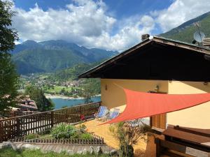 a house with a view of a river and mountains at Ca' Romantica - Ledro House in Pieve Di Ledro