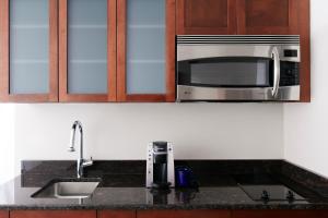 a kitchen with a sink and a microwave at Club Quarters Hotel Wacker at Michigan, Chicago in Chicago