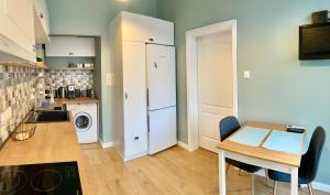 a small kitchen with a table and a refrigerator at Solunska Stylish Apartment in Sofia